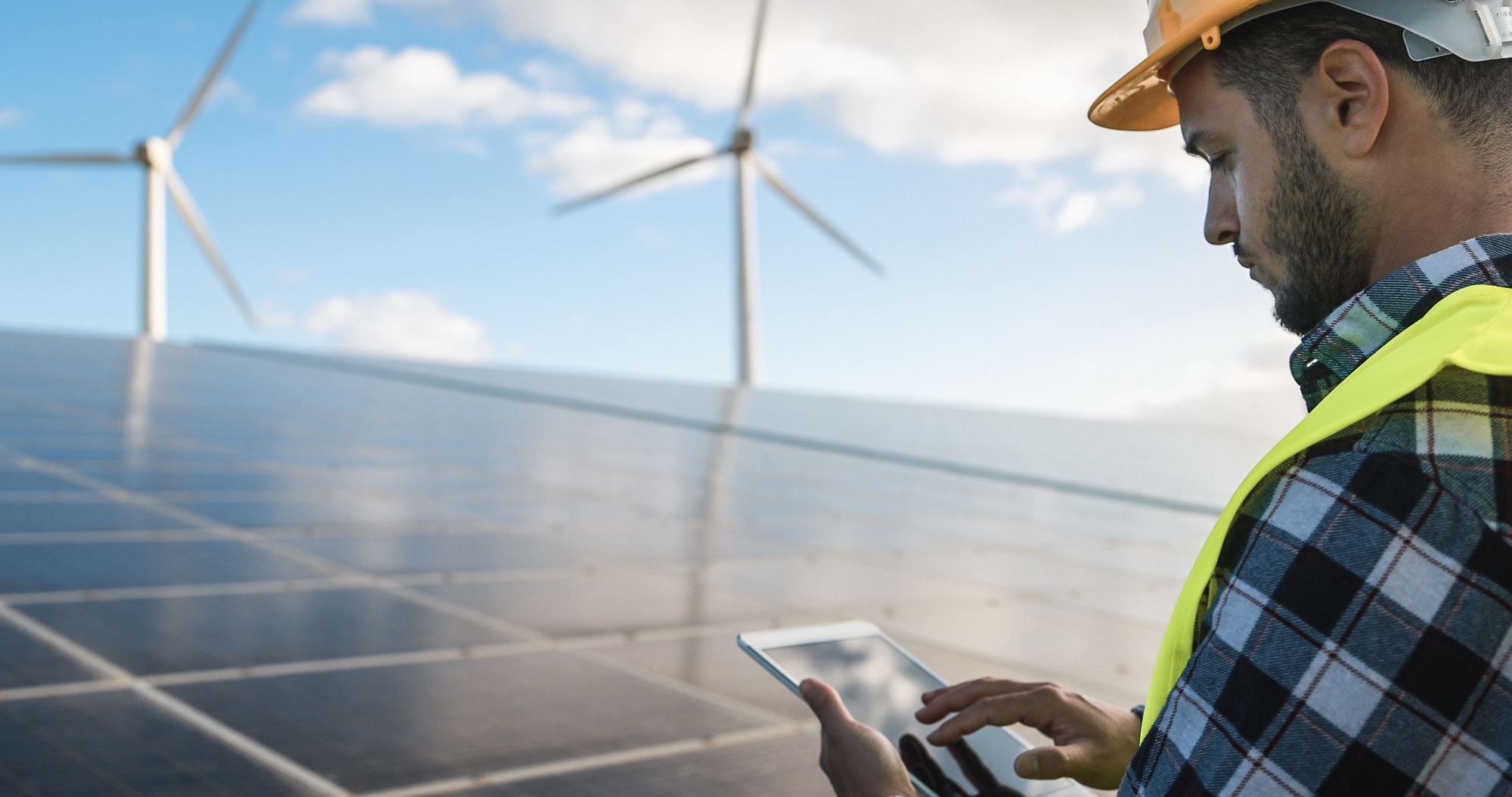 young-man-working-with-digital-tablet-at-renewable-energy-farm.jpg